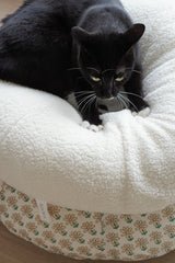 Tuxedo cat curled up in Ocatnip Marshmallow Pudding Bed, showcasing plush sherpa texture